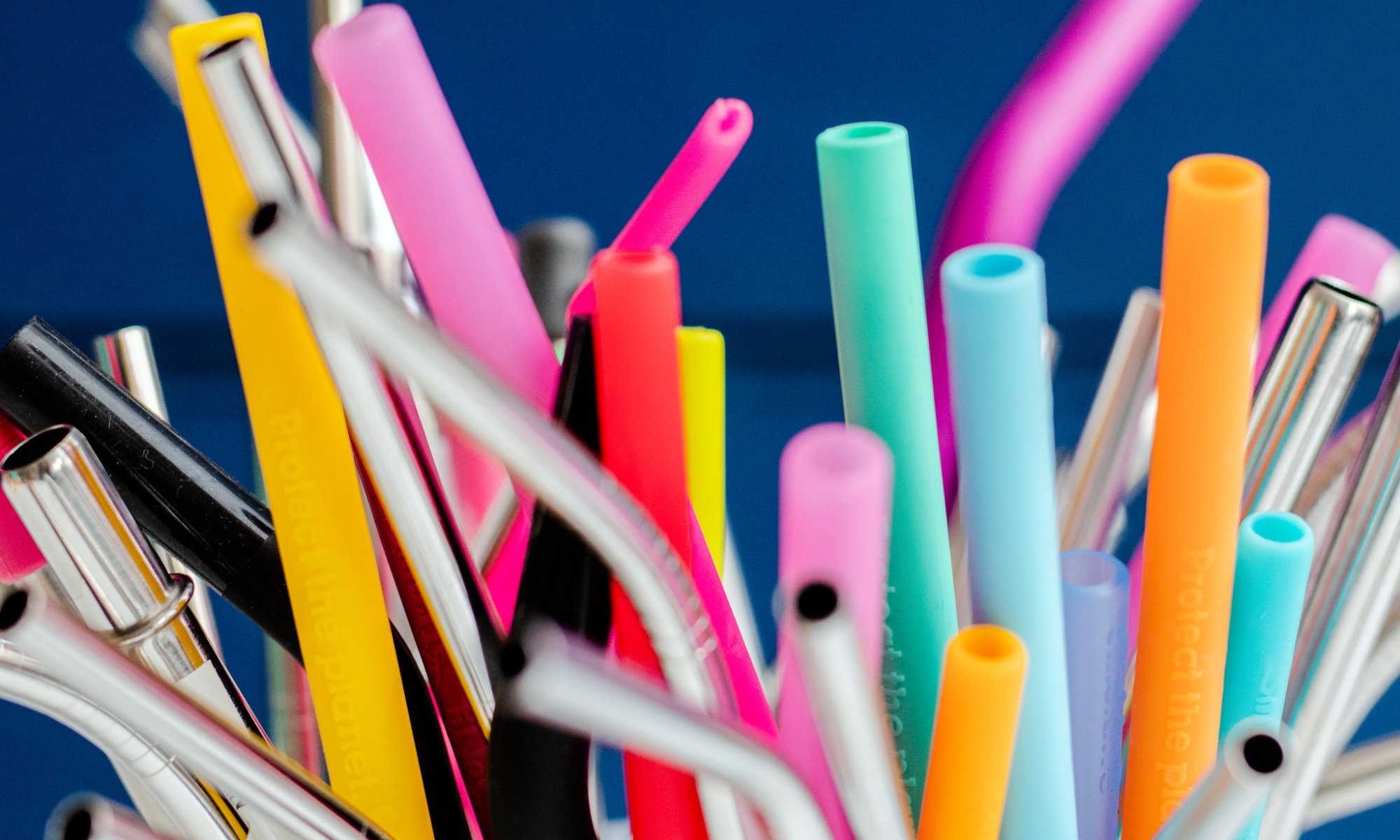A collection of colorful plastic and metal straws