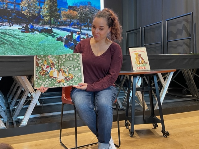 Kaitlyn reading her picture book in front of children