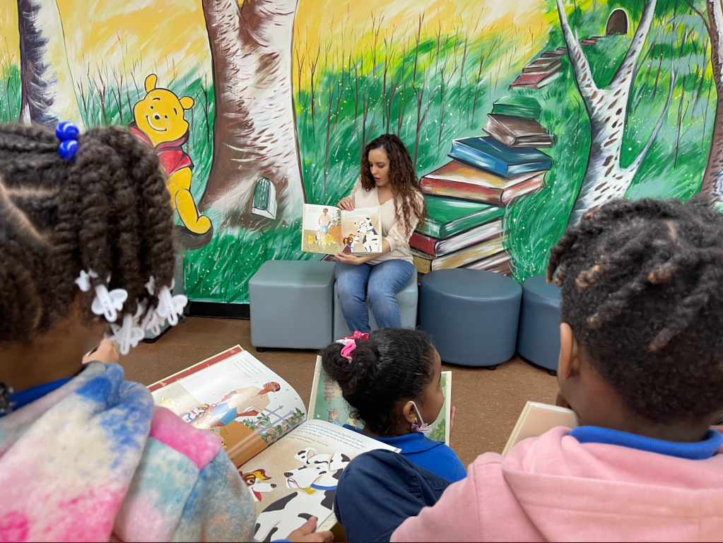 Kaitlyn Wells reading in front of a class